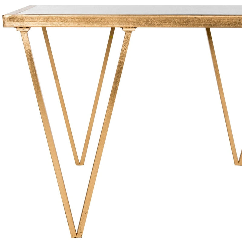 Mesa de centro dorada con acabado de pan de oro y superficie espejada